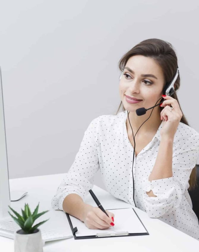 front-view-smiley-woman-writing-something-down-while-talking-headset